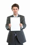 Modern businessman showing blank clipboard