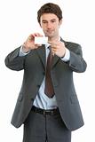 Modern businessman pointing on blank business card