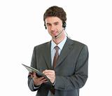 Modern business operator with headset writing in clipboard