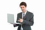 Angry businessman pointing in laptop
