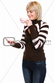 Happy middle age woman drinking tea