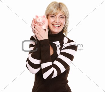 Smiling middle age woman holding piggy bank