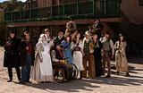 People outside a building in old west costumes
