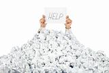 Person under crumpled pile of papers with a help sign / isolated