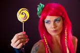 Girl with pink hair holding lollipop 