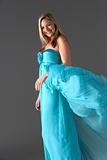 Full Length Studio Shot Of Young Woman In Blue Evening Dress