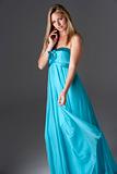 Full Length Studio Shot Of Young Woman In Blue Evening Dress