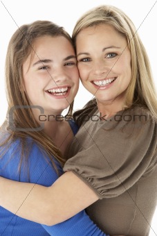 Studio Portrait Of Mother Hugging Daughter