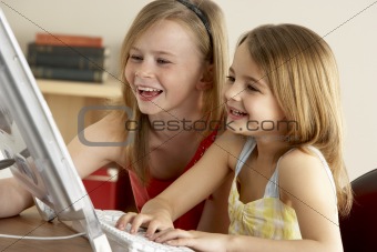 2 Young Girls Using Computer At Home
