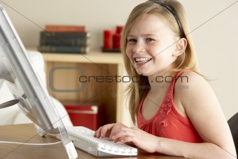 Young Girl Using Computer At Home