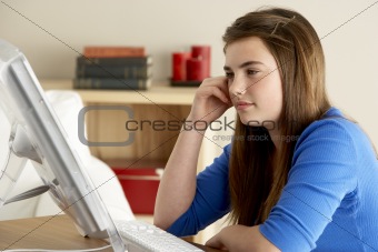 Teenage Girl Using Computer At Home