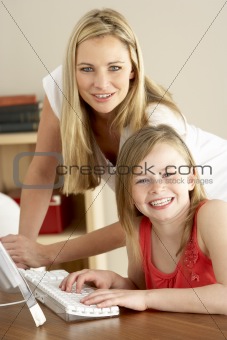 Mother And Daughter At Home Using Computer