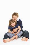 Studio Portrait Of Happy Brother And Sister