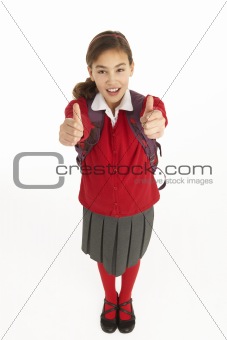 Studio Portrait Of Female Student In Uniform With Backpack