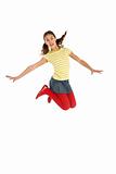 Mid Air Studio Shot Of Young Girl Jumping In Air