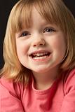Close Up Studio Portrait Of Smiling Young Girl