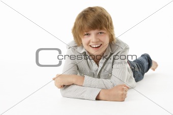 Young Boy Lying On Stomach In Studio