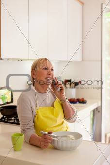 Retired woman preparing food at home