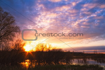 sunset above river