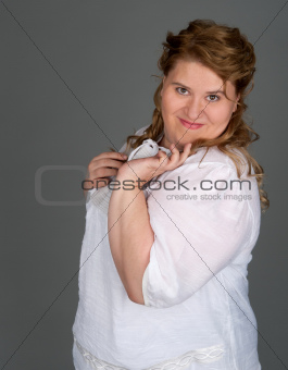 cheerful fat woman on gray background