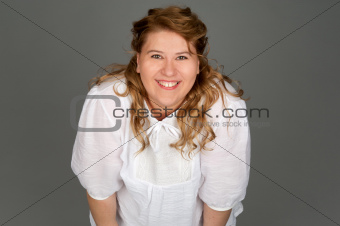 smiling fat woman on gray background