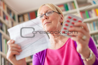 Senior woman with medication pills and prescription