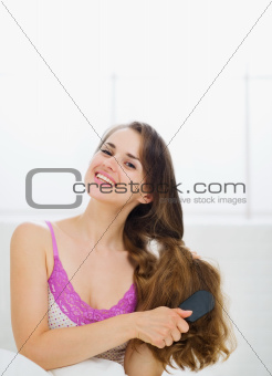 Beautiful woman combing luxury long hair