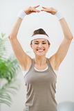 Smiling fitness woman making gymnastics exercise
