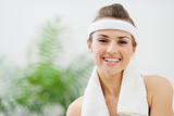 Portrait of smiling fitness woman with towel