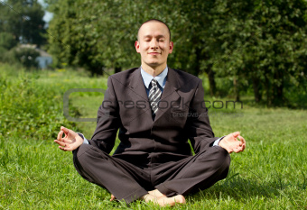 Businessman Meditating Outdoors 