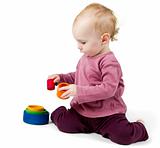 young child playing with colorful toy blocks