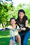 asian mother Teaching daughter To Ride A bicycle