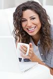Woman Smiling Drinking Tea or Coffee Using Laptop Computer