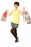 Studio Portrait Of Teenage Girl Carrying Shopping Bags