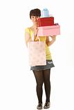 Studio Portrait Of Teenage Girl Carrying Packages And Shopping Bags