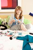 Teenage Girl In Untidy Bedroom Waxing Legs