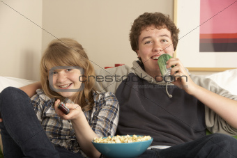 Teenage Couple Sitting On Sofa Watching TV