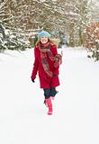 Woman Walking Through Snowy Woodland