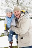 Father And Son Standing Outside In Snowy Landscape