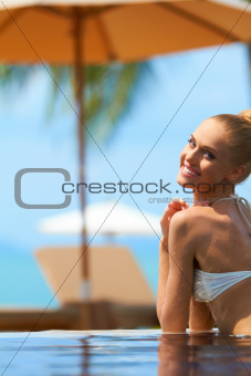 Woman in bikini at tropical resort