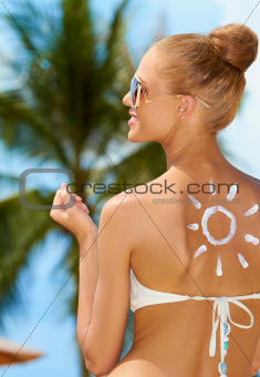 Smiling woman with the sun painted on her back