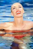Laughing woman relaxing in a pool