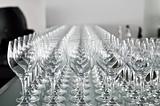 A lot of wine glasses in a row