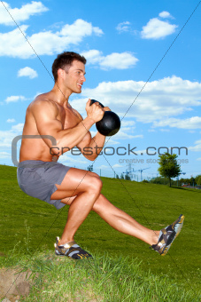 Exercises with kettlebell in sunny weather