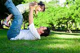 happy father and little girl on the grass