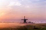 Dutch windmill in fog in the early morning
