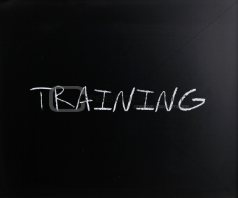 "Training" handwritten with white chalk on a blackboard