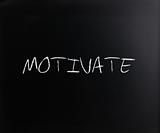"Motivate" handwritten with white chalk on a blackboard