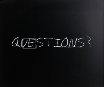 "Questions?" handwritten with white chalk on a blackboard