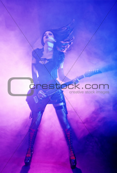 Sexy woman plays guitar at the concert
